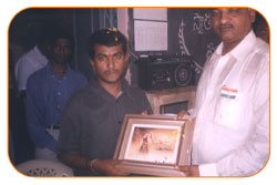 Mr. N Bitra Receiving A memento from Pinnamaneni Venkateswara Rao, Minister Technical Education, on the occasion of 56th Independence Day (15th August 2003). Bitra Net Pvt. Ltd., has donated two letest configuration computers to a School located in Puttagunta (Krishna Dist, Andhra Pradesh)